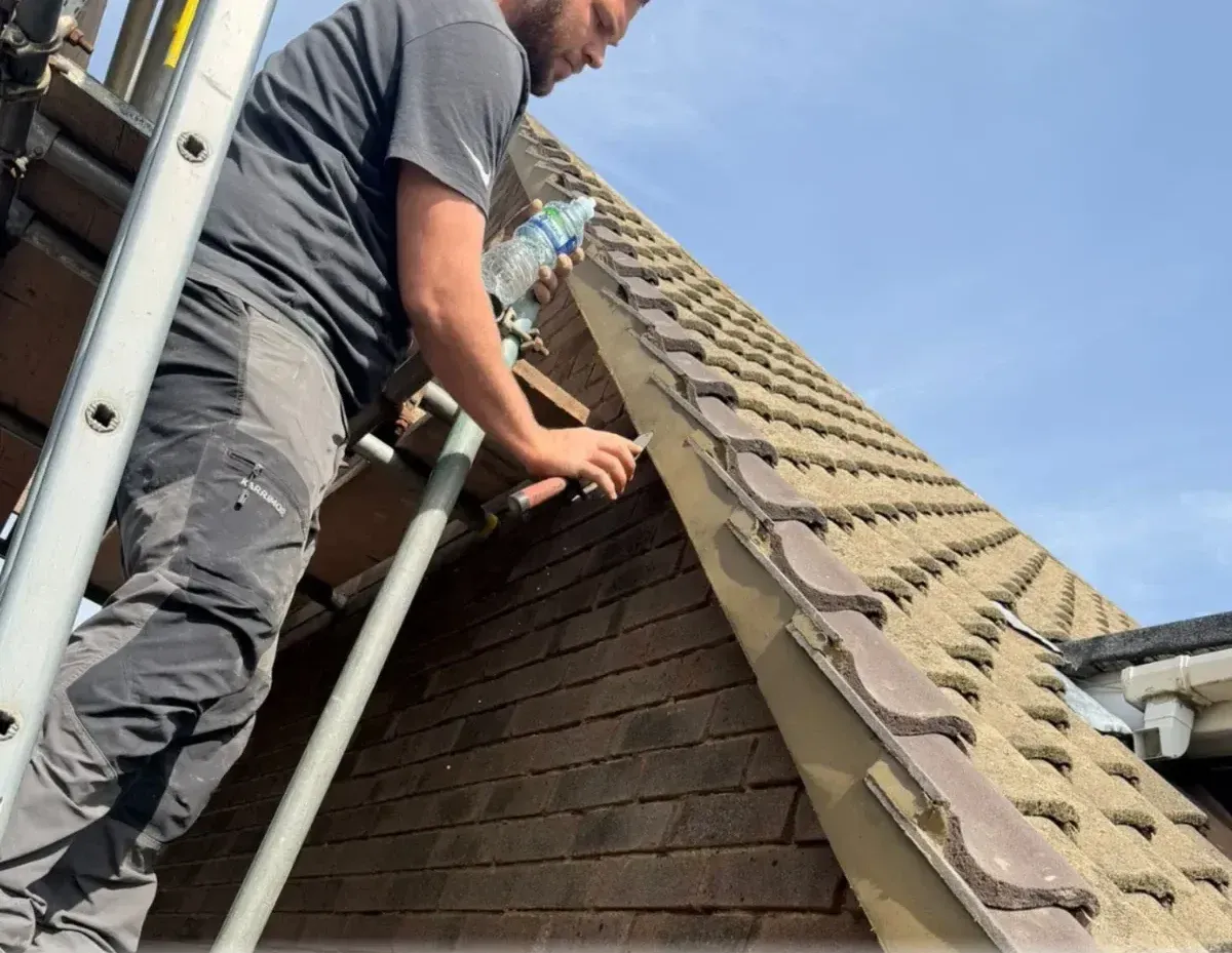 An FJC Roofing team member at work on a roof